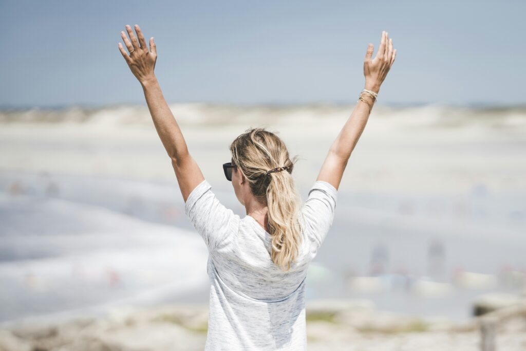 Woman holding hands up and enjoying the elegant mindset transformation she has started.