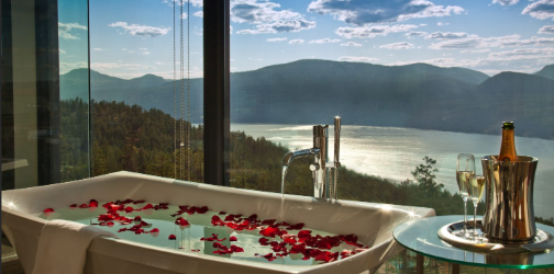 Sparkling hill luxury spa getaway room bath, champagne and stunning view.