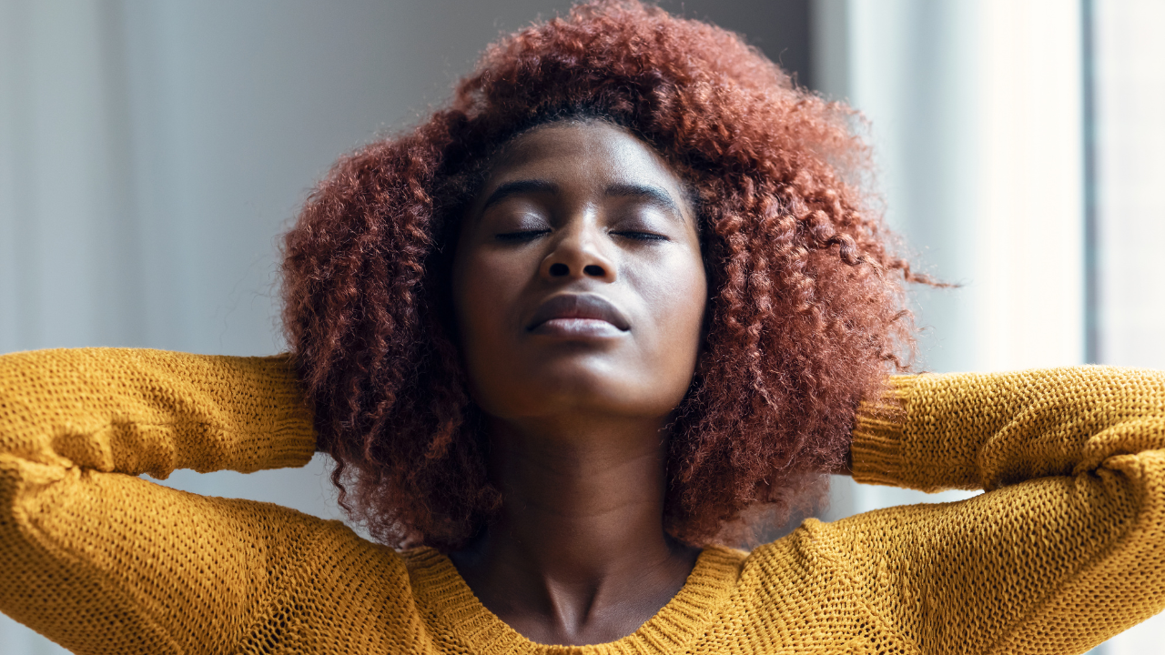 woman taking in deep breathes to calm her stress and make life-changing habits.